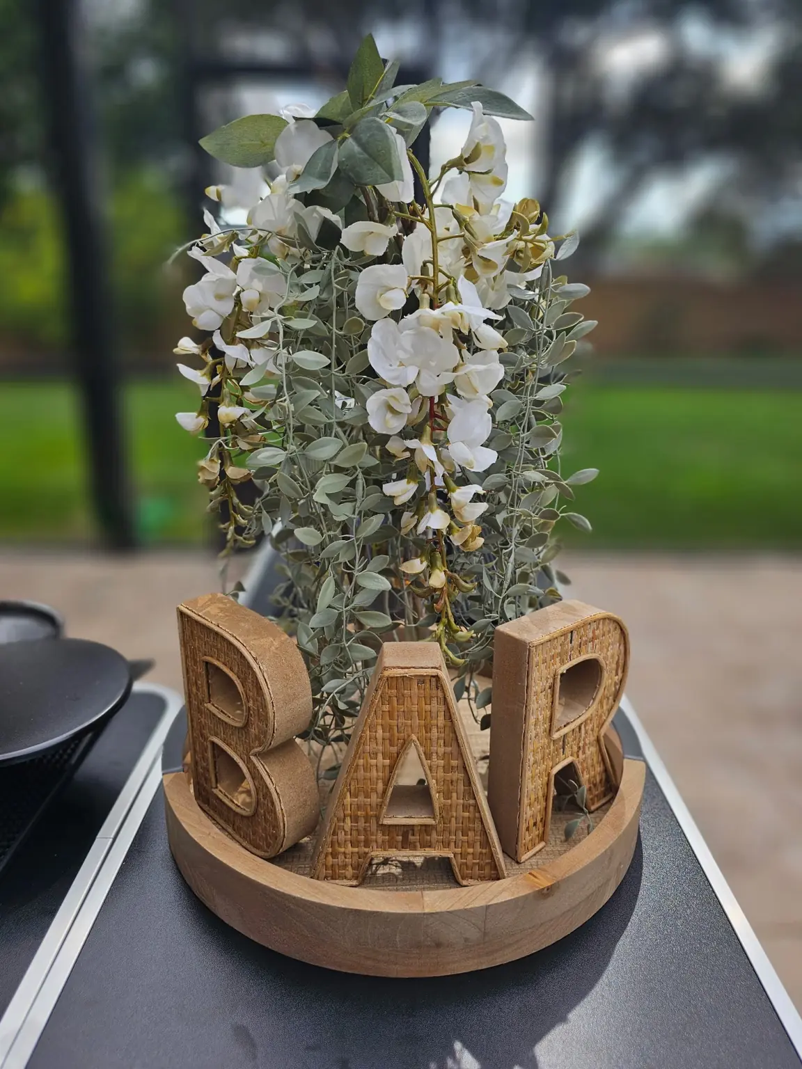 Decorative bar sign with floral arrangement