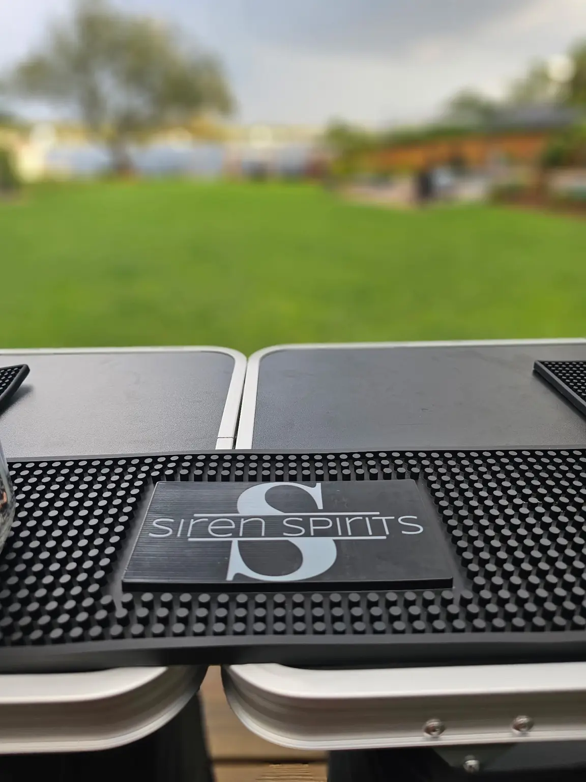 Closeup of Siren Spirits logo on a bar mat
